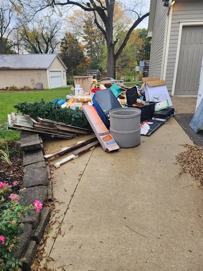 Dumpster being loaded with debris for 12 Yard Dumpster Rental in Grattan